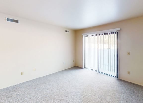 spacious living room with a sliding glass door to a private patio at Walnut Trail Apartments in Portage, MI 49002
