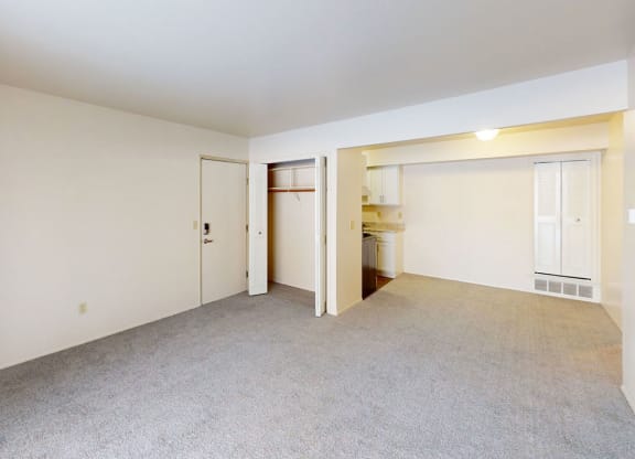 living room with a closet and dining area at Walnut Trail Apartments in Portage, MI 49002