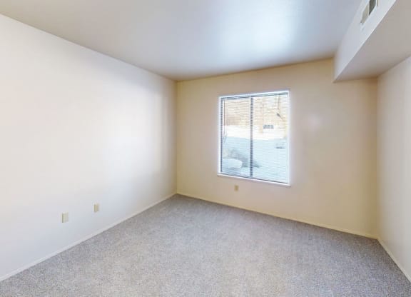 bedroom with a large window at Walnut Trail Apartments in Portage, MI 49002