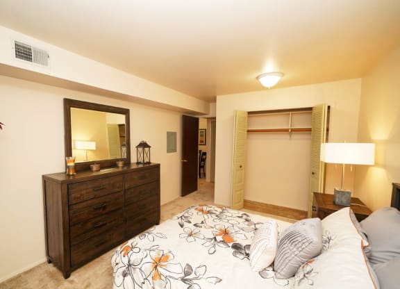 Carpeted Bedroom With Large Closet at Walnut Trail Apartments, Michigan