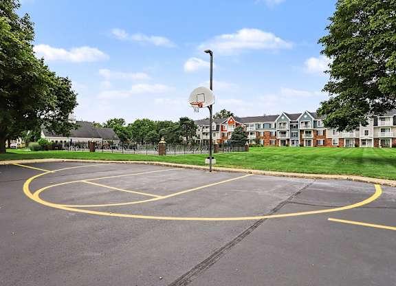 A basketball court with a hoop at Walnut Trail Apartments, Michigan