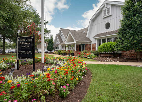 A sign for the Leasing Center & Resident Services at Waterfront is in front of a building at WaterFront Apartments, Virginia Beach, 23453