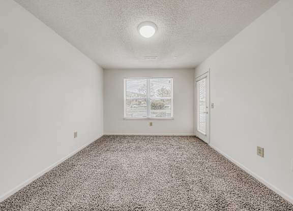 A room with a carpeted floor and a picture on the wall at WaterFront Apartments, Virginia Beach, 23453