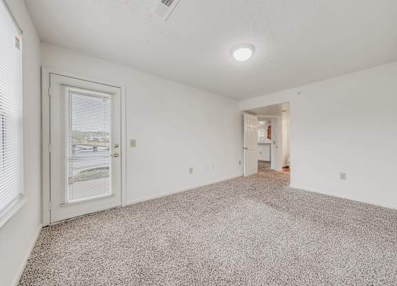 A room with a carpeted floor and a ceiling fan at WaterFront Apartments, Virginia Beach, 23453