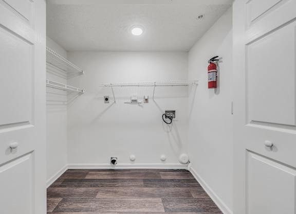 A white closet with a fire extinguisher on the wall at WaterFront Apartments, Virginia Beach, 23453