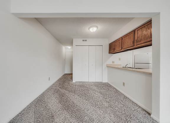 A room with a carpeted floor and a white wall at WaterFront Apartments, Virginia Beach, 23453
