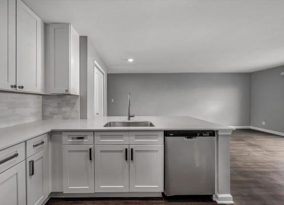 the kitchen of a new home with white cabinets and a sink at WaterFront Apartments, Virginia Beach, 23453