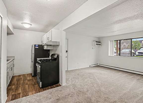 A kitchen with a fridge, stove, and oven.
