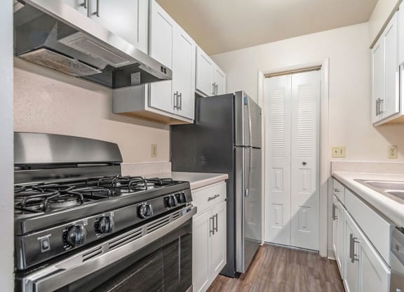 white kitchen with stainless steel appliances at West Wind Apartments in Fort Wayne, IN