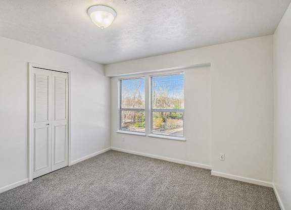 A room with a window and a door at West Hampton Park Apartments in Elkhorn, NE 68022