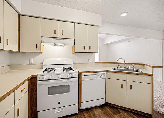 A kitchen with a white gas stove and dishwasher  at West Hampton Park Apartment Homes, Nebraska, 68022