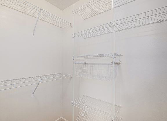 A walk-in closet with wardrobe organizers at West Hampton Park Apartments in Elkhorn, NE 68022