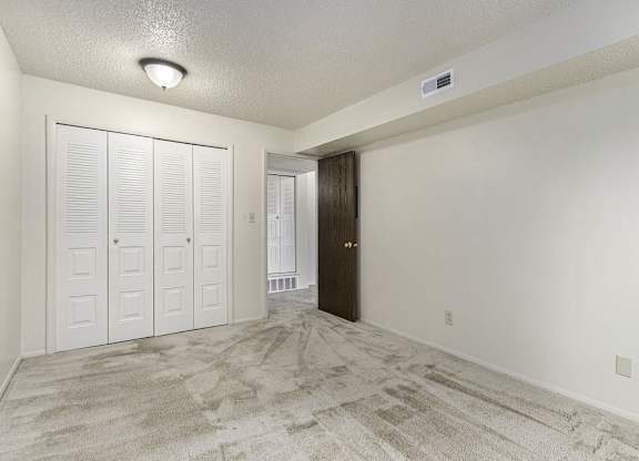A bedroom with a large closet at West Wind Apartments, Fort Wayne, 46808