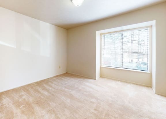bedroom with a large window at Windmill Lakes Apartments, Holland, 49424