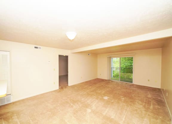 living room and dining room with plush carpeting at Windmill Lakes Apartments, Holland, 49424