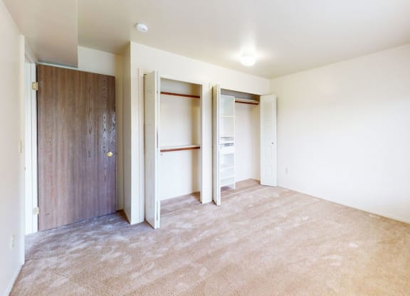 bedroom with doors to a large closet with organizers at Windmill Lakes Apartments, Holland, 49424