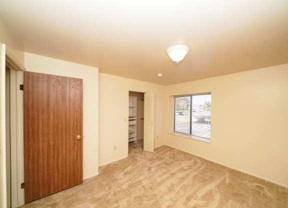 second bedroom with a walk-in closet at Windmill Lakes Apartments, Holland, 49424