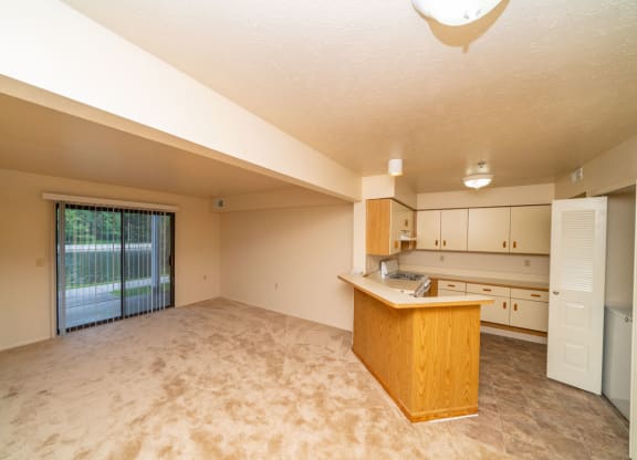 Living Room with Slider to Patio at Windmill Lakes Apartments, Holland, 49424