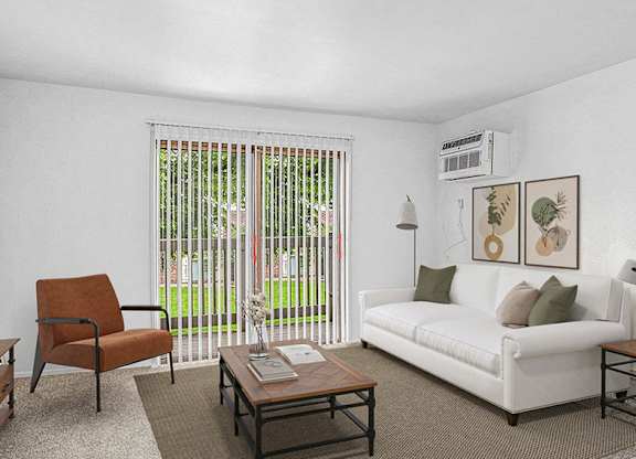 A living room with a white couch, a brown chair, and a coffee table at Wingate Apartments, Michigan