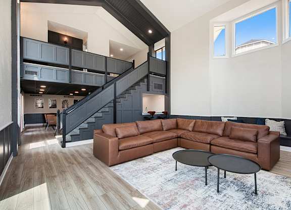 A community room with a brown couch and a black coffee table at Wingate Apartments, Kentwood