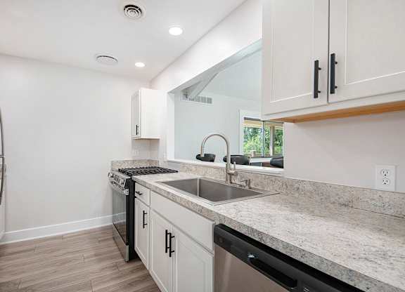 A modern kitchen with stainless steel appliances at Wingate Apartments, Kentwood