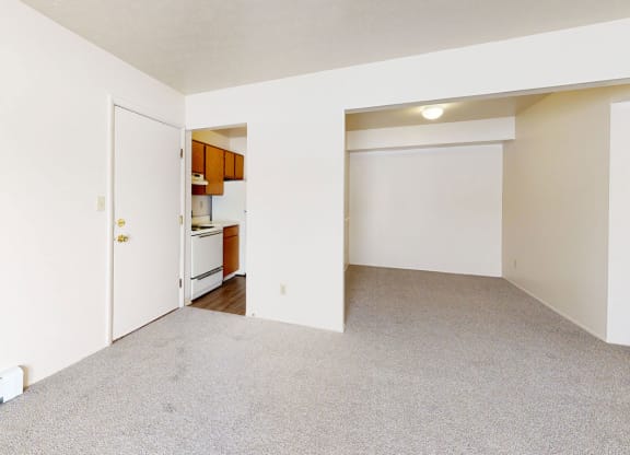 living and dining areas with plush carpeting  at Wood Creek Apartments, Kenosha, WI