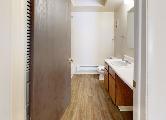spacious bathroom with a sink and a toilet  at Wood Creek Apartments, Wisconsin