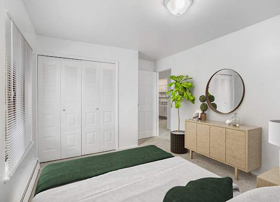 A spacious bedroom with a bed, dresser, and a large closet at Wood Creek Apartments, Kenosha, WI, 53144