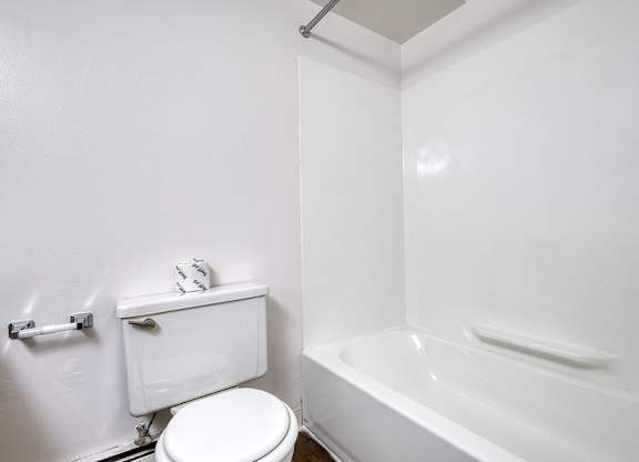 A bathtub and toilet in a bathroom at Wood Creek Apartments, Kenosha