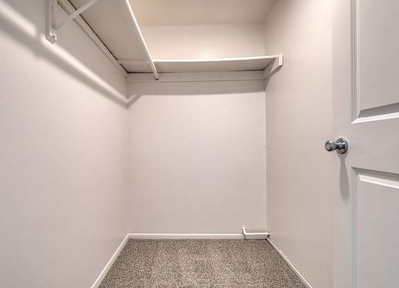 A large bedroom with a carpeted floor at Wood Creek Apartments, Kenosha