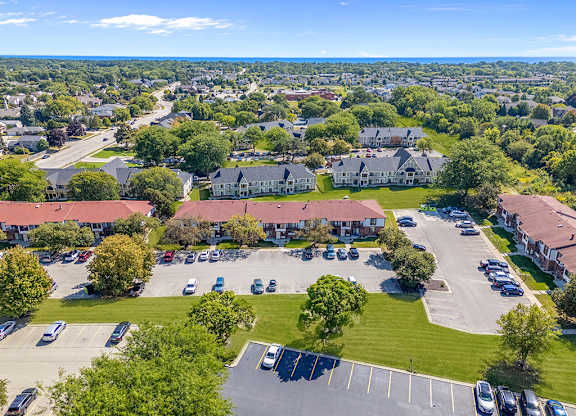 Park-like grounds with mature shade trees at Wood Creek Apartments, Wisconsin