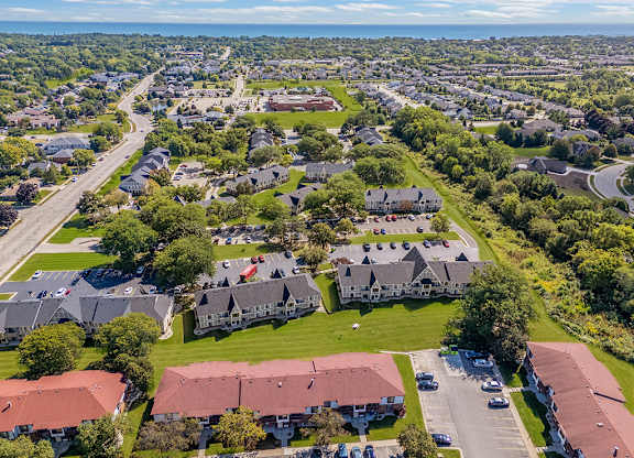 A bird's eye view of a community with buildings and grassy areas at Wood Creek Apartments, Wisconsin