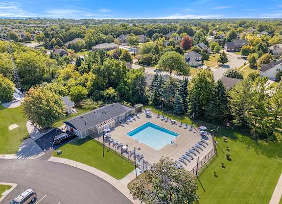 A bird's eye view of an apartment community with a swimming pool at Wood Creek Apartments, Wisconsin