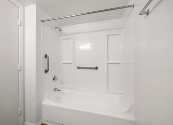 A white bathroom with a tub and shower.