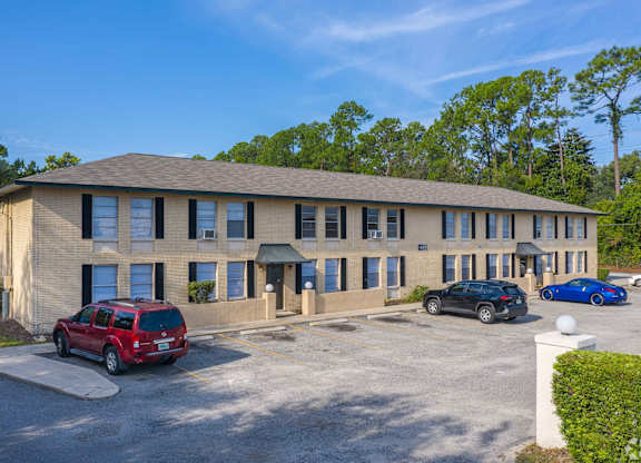 A building with a parking lot in front of it.