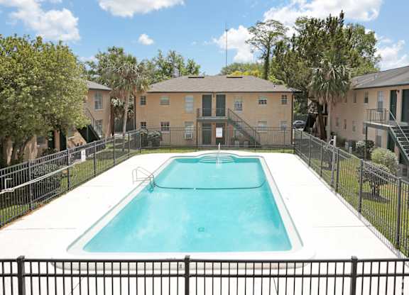 A swimming pool surrounded by a black fence.