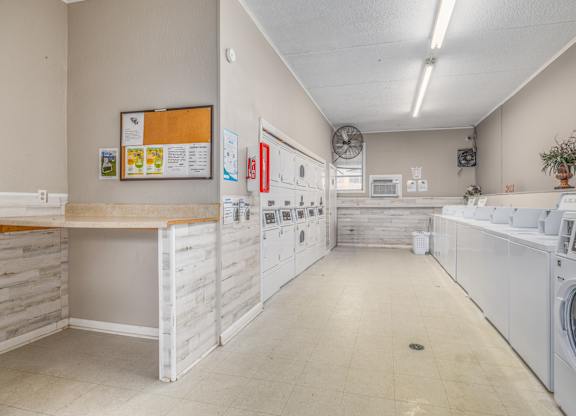 A laundry room with washers and dryers.