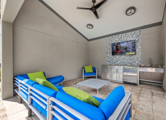 a living room with couches and a table and a tv at Pavilion Luxury Apartments, Riverview, FL, 33578