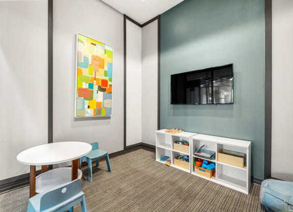 a room with a table and chairs and a television at Pearce at Pavilion Luxury Apartments, Florida, 33578