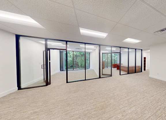 A spacious room with glass doors leading to a balcony.
