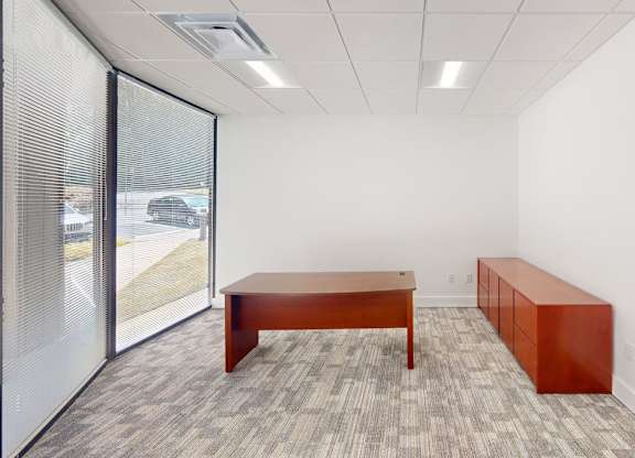 A room with a long table and a bench.