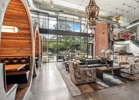 Resident clubhouse with many seating areas with couches, work booths, and chairs