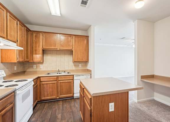 A kitchen with wooden cabinets and a white appliances