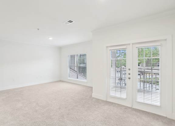 Spacious living room with big windows and natural light