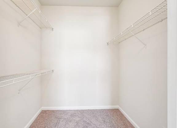 A large walk-in closet with shelves.
