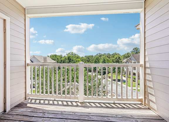 A view from a porch looking out at a residential neighborhood.