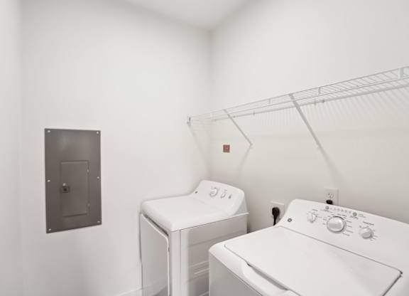 A white washing machine and dryer in a laundry room.