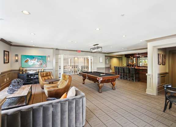 Resident Clubhouse: a large room with a pool table and comfortable seating at the bar with a coffee machine