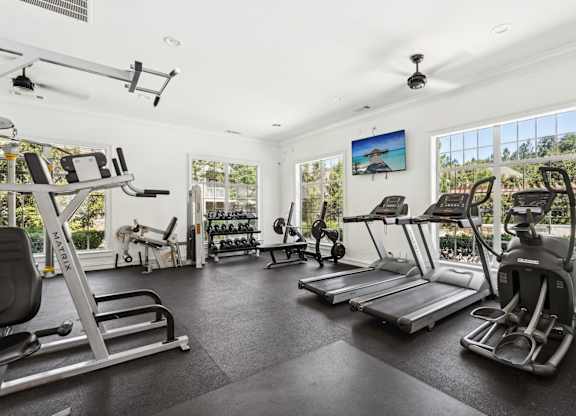 A spacious gym with a variety of exercise equipment.