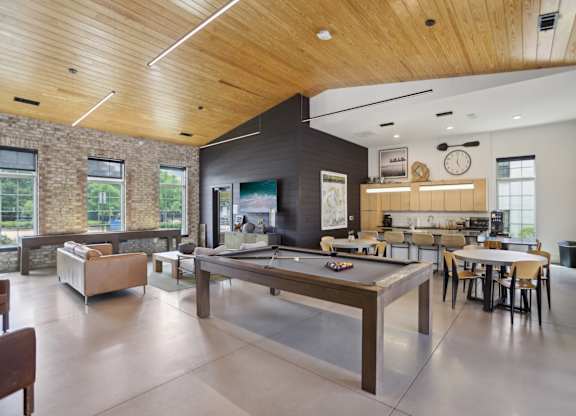 Resident clubhouse with a tv, billiards, dining and bar area with kitchen and coffee machine